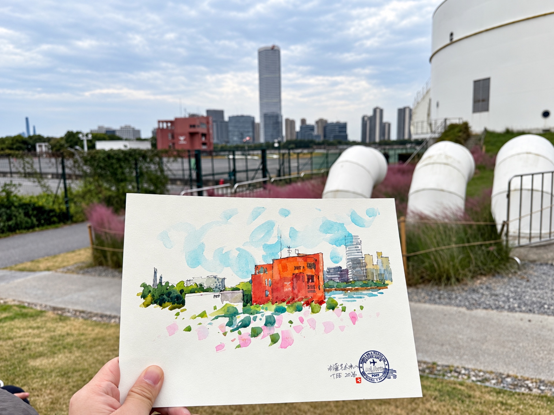 My watercolor of the red building, held in front of the scene